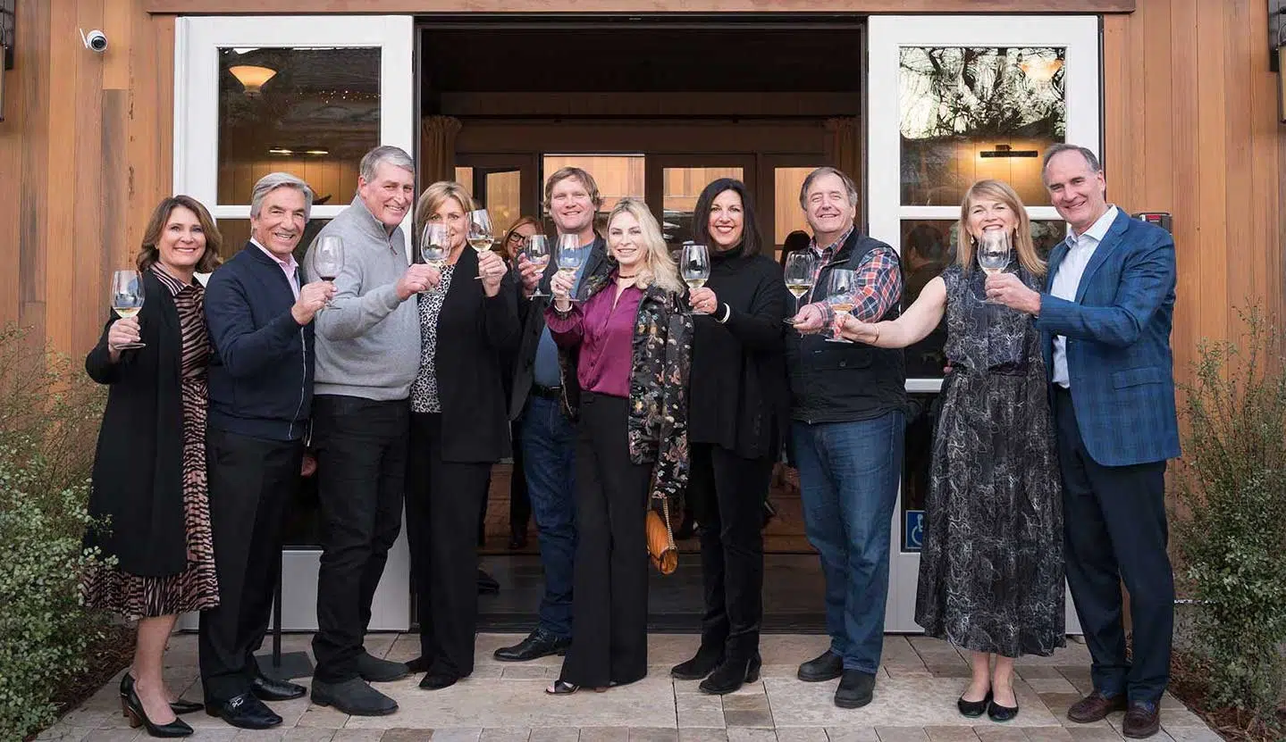 Ownership and Winemaker doing a toast in front of Handwritten Wines tasting room