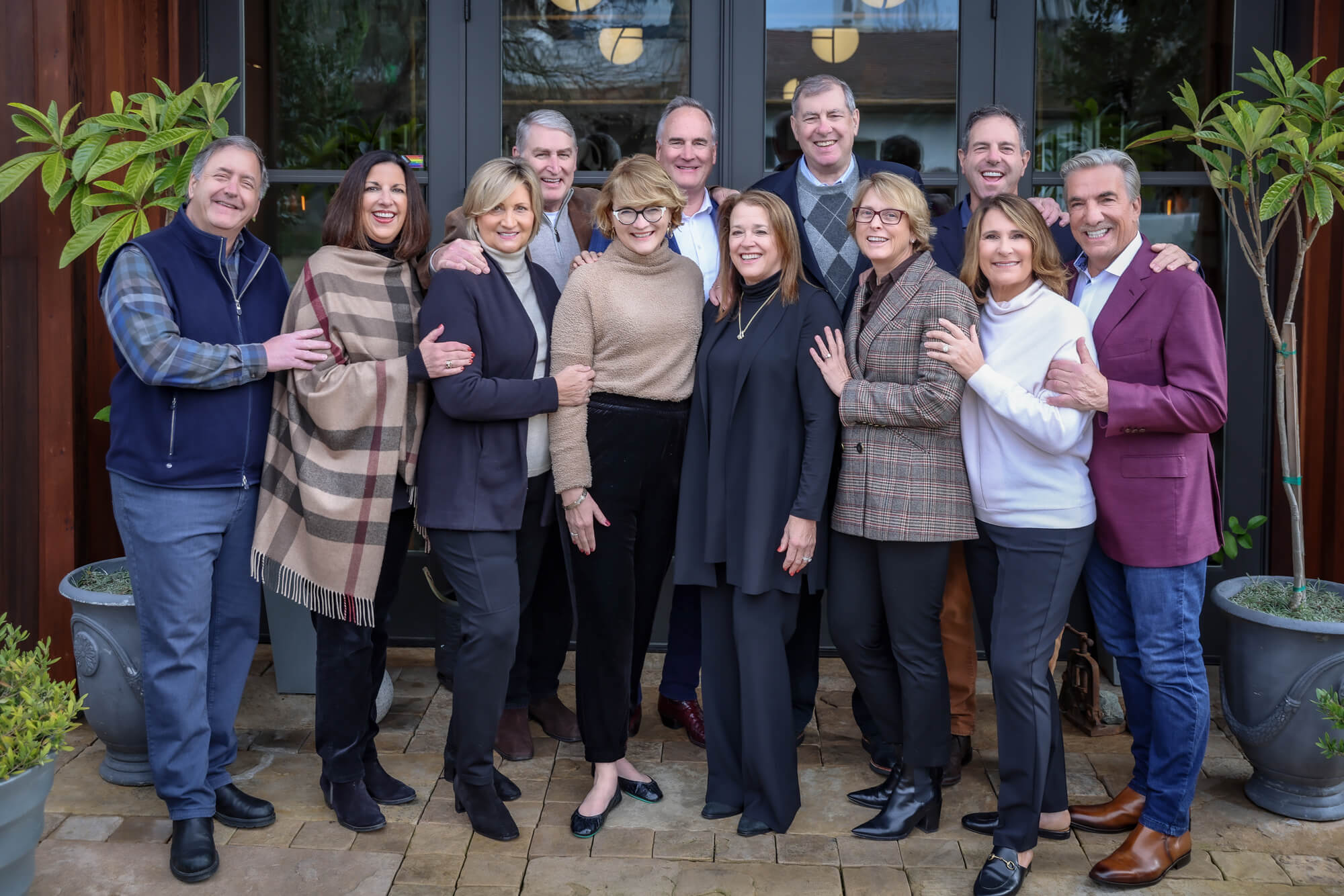 group of people smiling - owners of handwritten wines