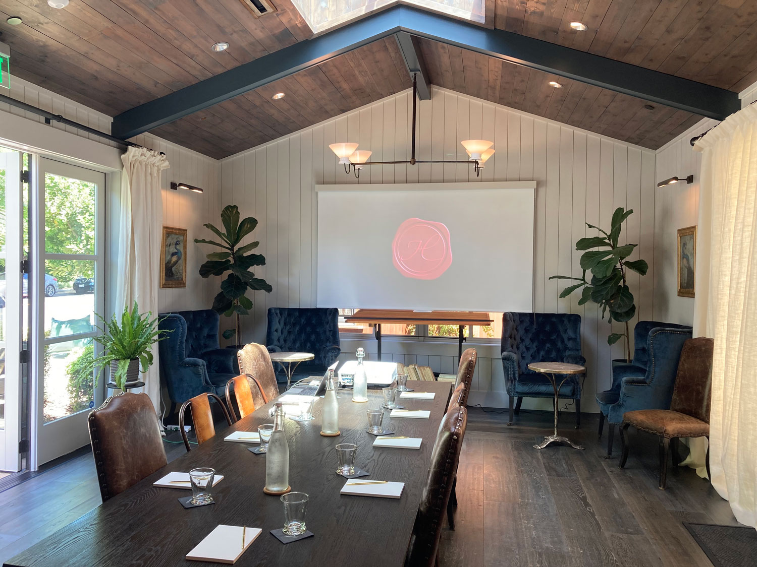 Handwritten Wines meeting room shown with projector and large table set up