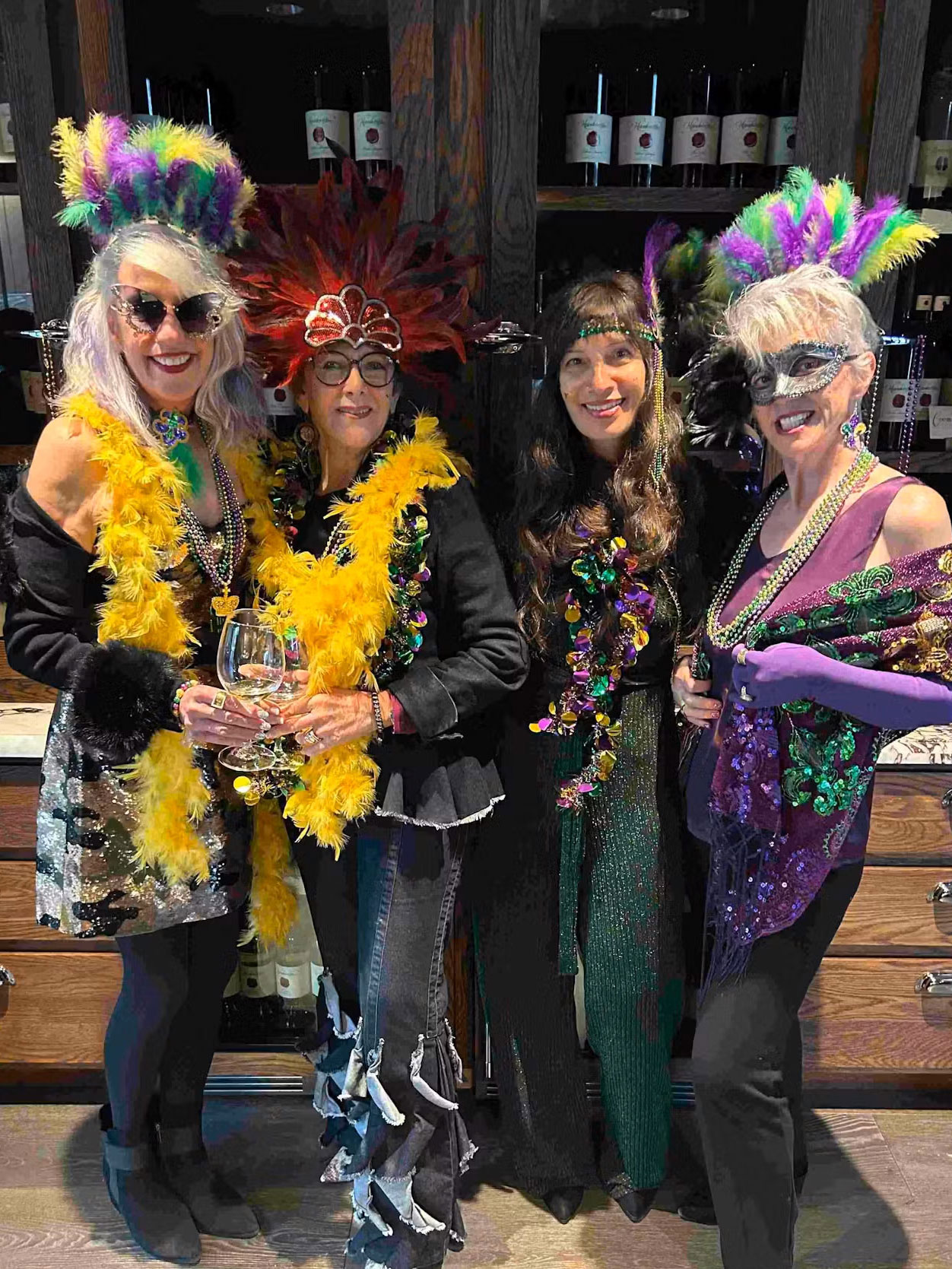 group of four ladies celebrating Mardi Gras at Handwritten