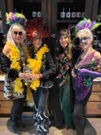 group of four ladies celebrating Mardi Gras at Handwritten